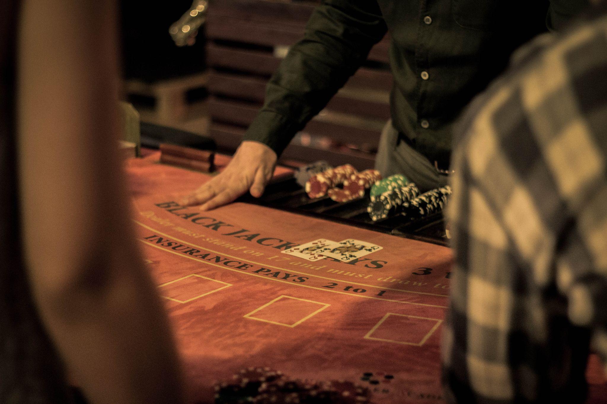 Picture of a blackjack table with people around