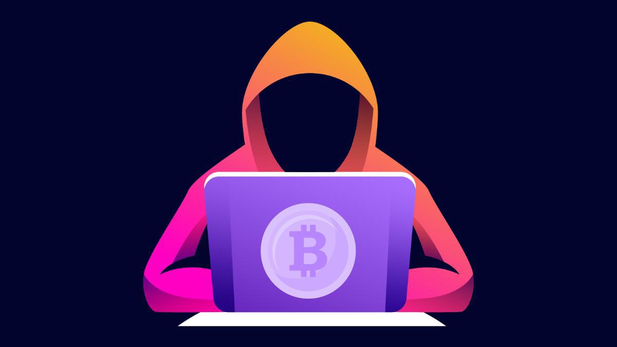 Silhouette of person in orange hoodie on dark background with bitcoin logo'd laptop