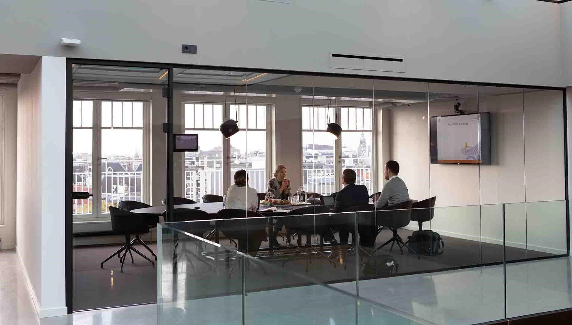 An image of 4 people in a meeting in an office