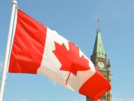 An image Canadas flag in front of a clock tower